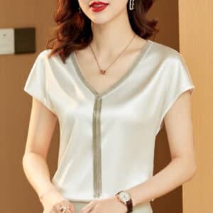 Blouse en satin blanche à manches courtes avec accents dorés